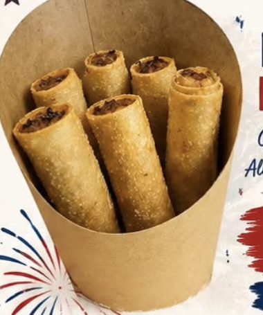 Classic pork lumpia — golden fried spring rolls standing in a kraft paper cone